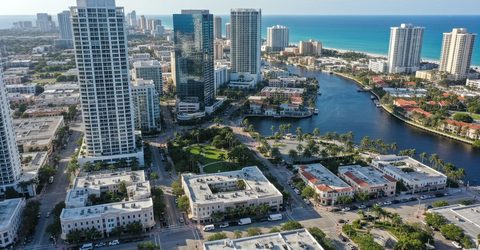 Aerial view of Fort Lauderdale waterfront high-rises, canals and boats on a clear day.
